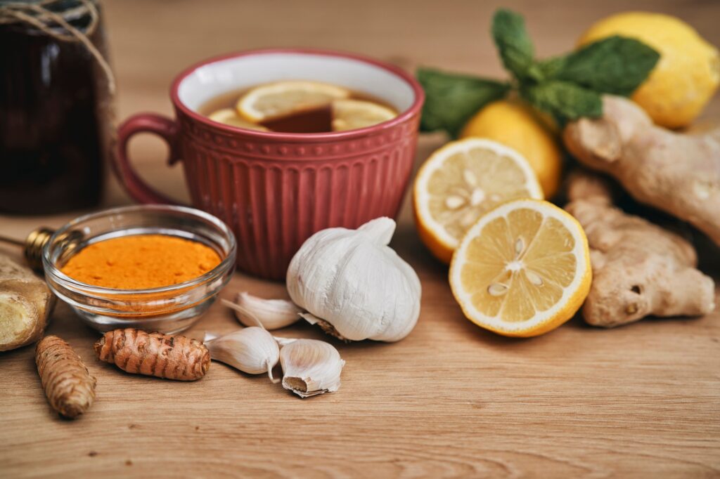 Horizontal composition of winter tea and natural antioxidants on wooden desk